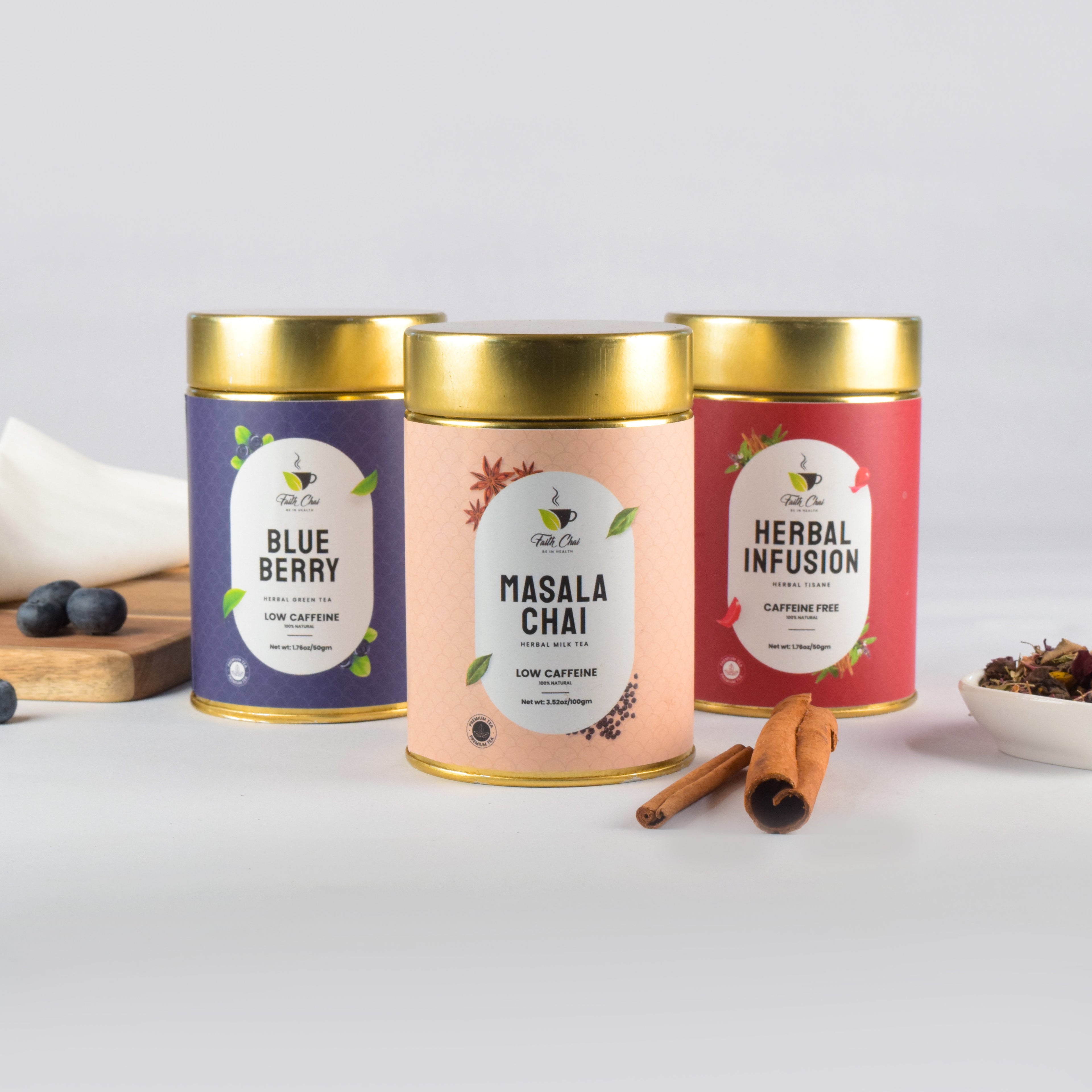 Three tea canisters labeled 'Blue Berry', 'Masala Chai', and 'Herbal Infusion' on a white background.